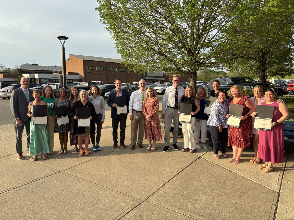 Volunteers of the Year pose for a photo outside the school